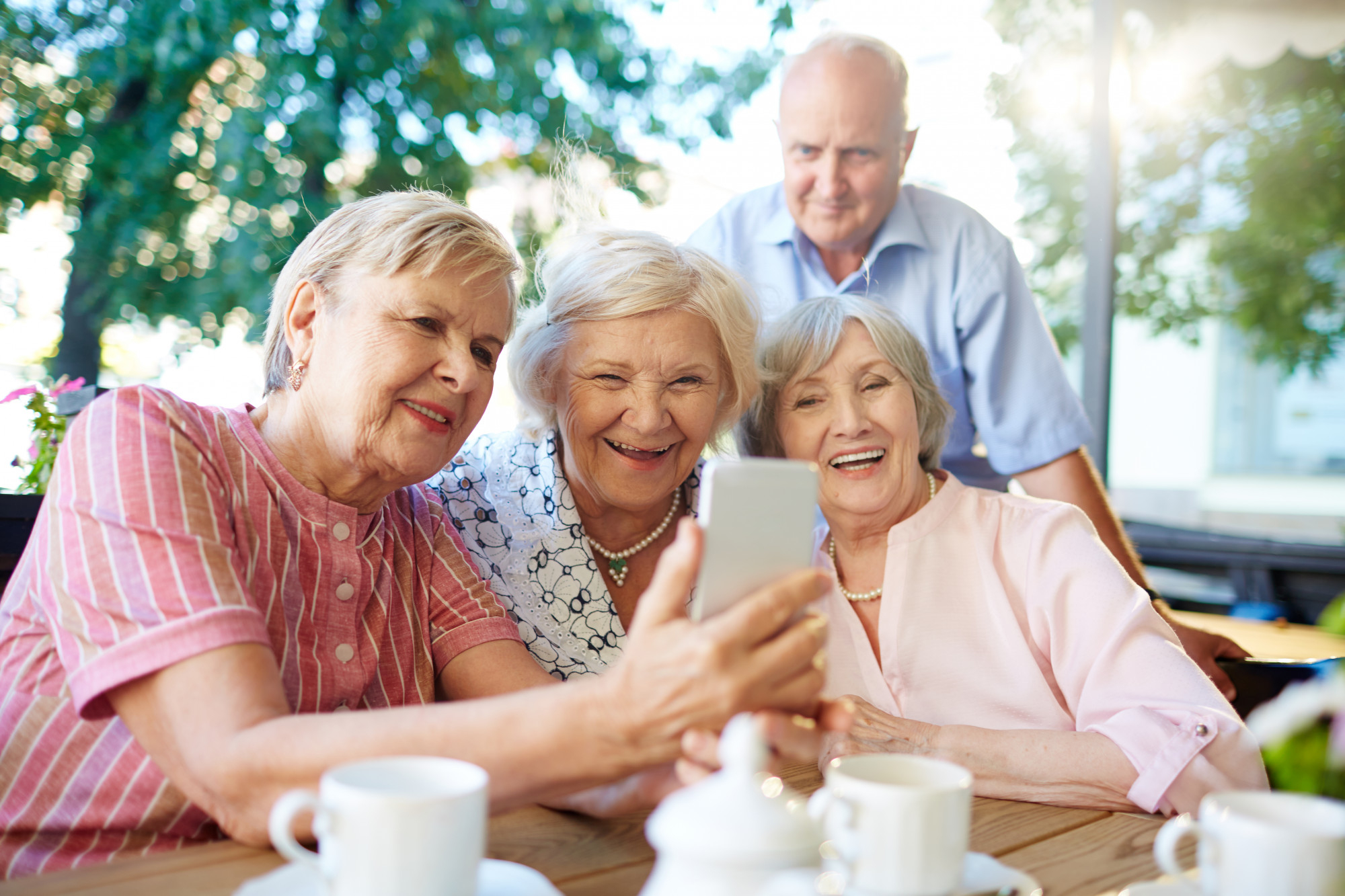 A group of seniors smiling together at a senior living facility in Southern California.