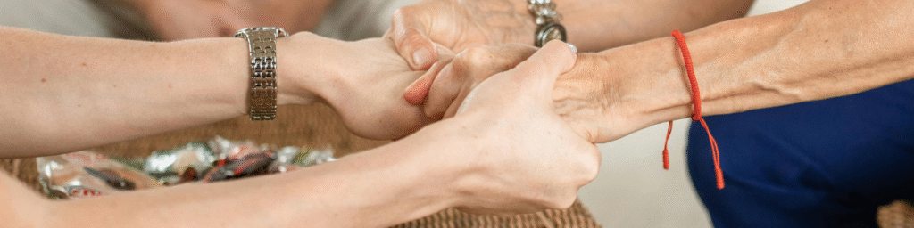 Seniors holding hands with a Vineyard Seniors Advisor