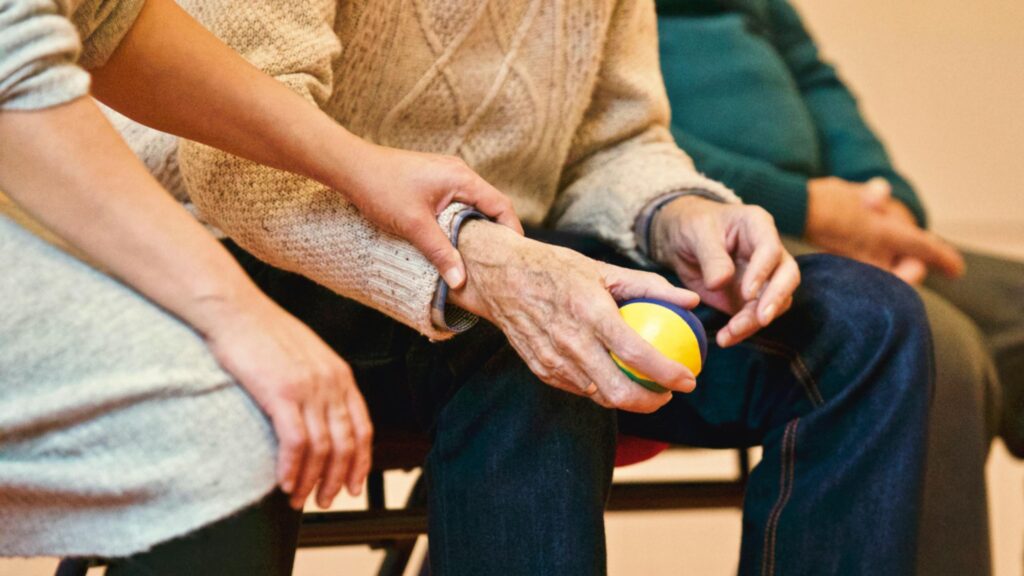 Seniors holding hands in a senior living community in the Orange County area.